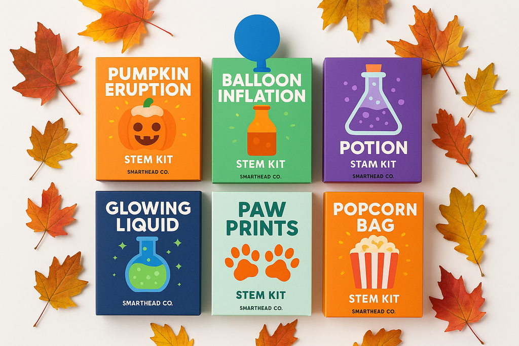A square flat-lay product photo showing all six STEM kits together: pumpkin eruption, balloon inflation, potion, glowing liquid, paw prints, and popcorn bag. Styled with autumn leaves and SmartHead Co.™ branding. Clean, colorful, magical fall science collection on a white background.”